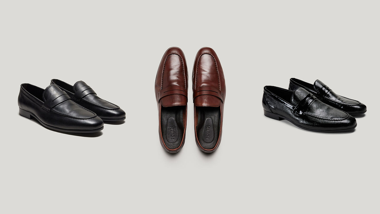 Men’s leather loafers in black and brown displayed in a clean flat lay — premium footwear gift ideas under $200.