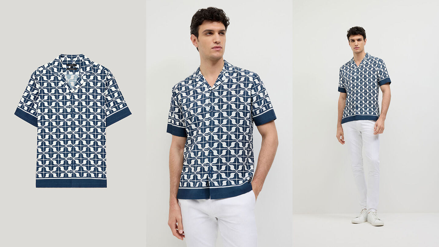 POLITIX Chadwick Geo short sleeve shirt in navy geometric print, shown as flat lay and worn with white pants.