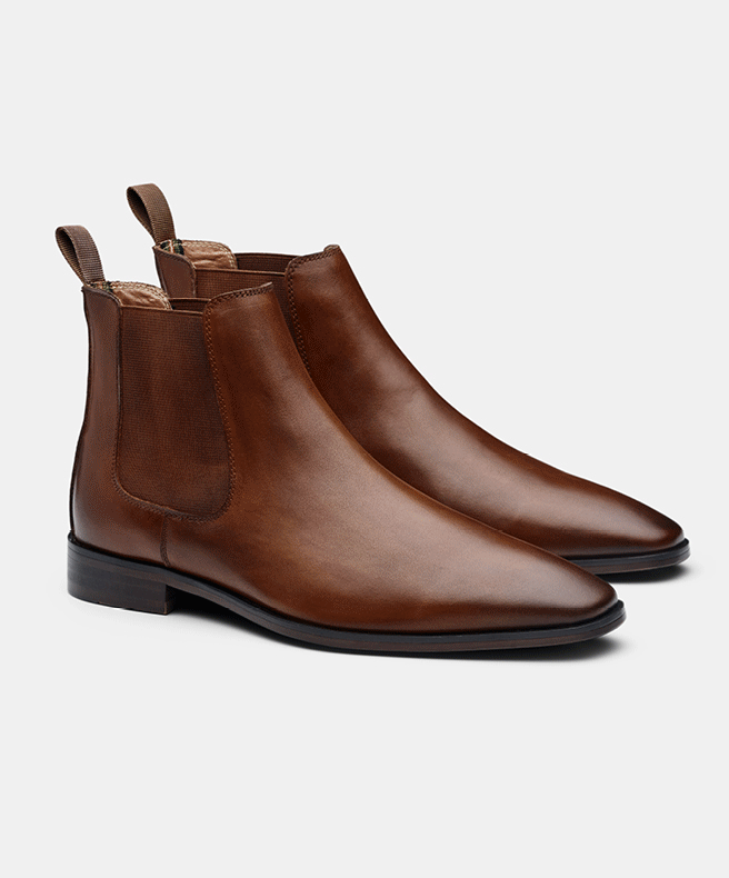 Brown and black leather chelsea boots side by side