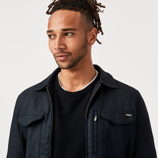 Model wearing overshiModel wearing a navy shacket from Politixrt with jeans Model wearing a navy shacket from Politix