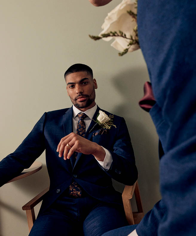Male model in Navy blue POLITIX suit seated