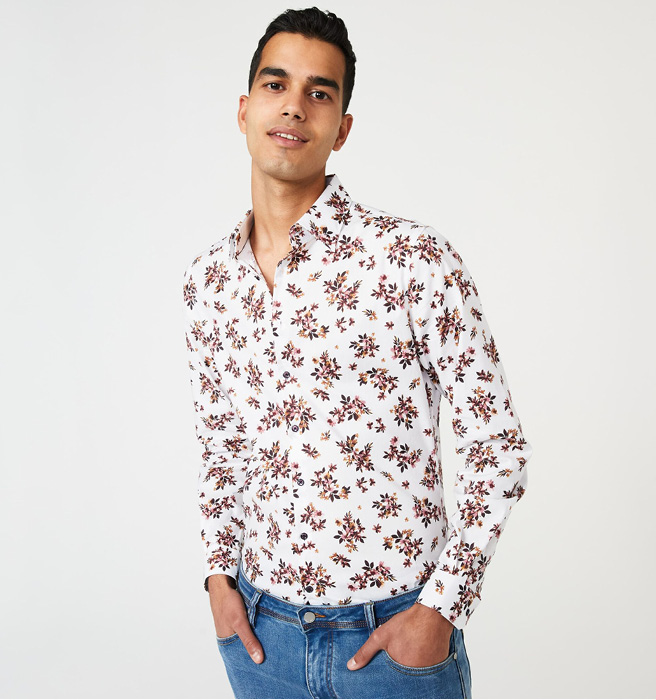 Model wearing button up shirt with floral prints Model wearing button up shirt with floral prints