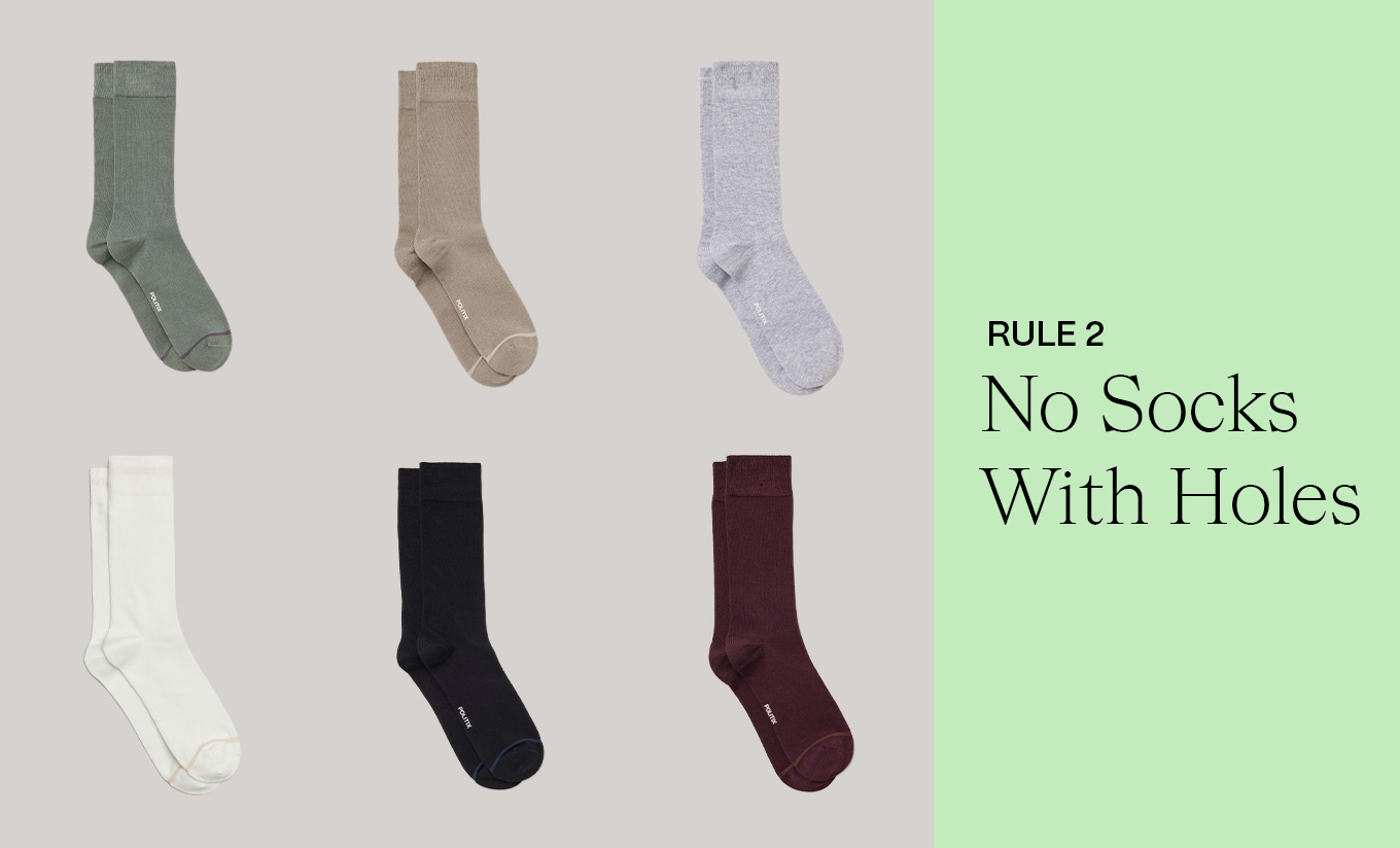 Six pairs of POLITIX men’s socks in muted tones of green, beige, grey, white, black, and burgundy, displayed neatly on a neutral background. Text overlay reads ‘Rule 2: No Socks With Holes,’ highlighting the importance of polished details in spring dressing.
